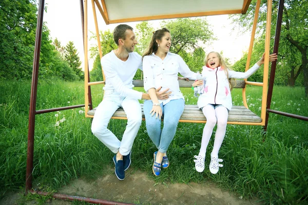 Schwangere mit Tochter und Mann beim Spaziergang im Park — Stockfoto