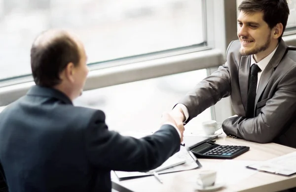 Geschäftsmann schüttelt seiner Partnerin die Hand, um einen Deal zu besiegeln — Stockfoto