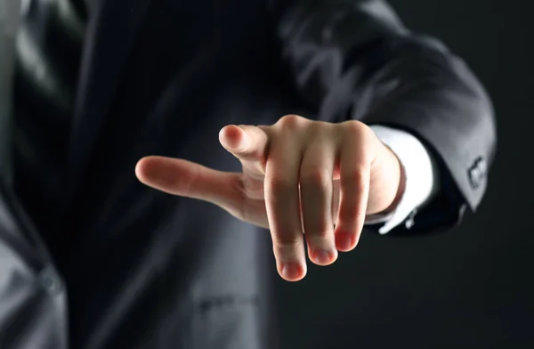 Businessman hand pressing an imaginary button on the virtual screen  a black background — Stock Photo, Image