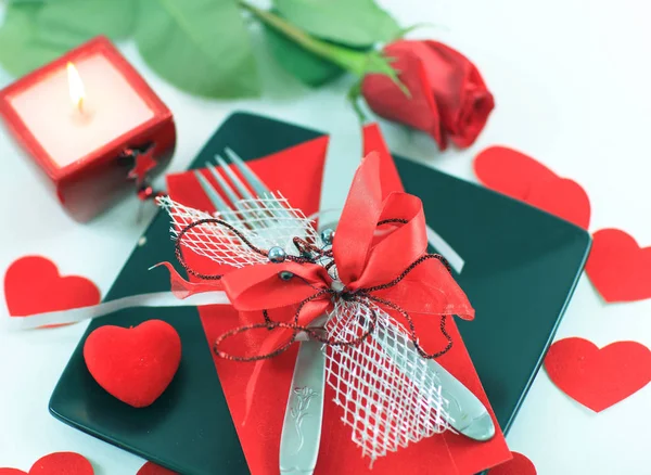 Cutlery on dark plate with a candle decorated for Valentines day — Stock Photo, Image