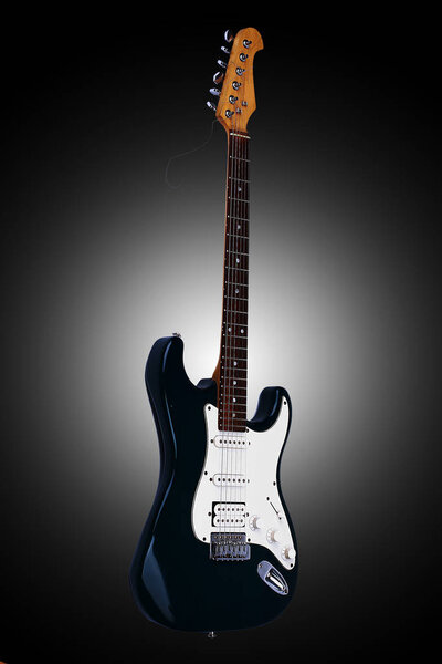 Beautiful guitar. Isolated on a black background with vignette