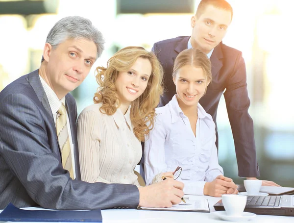 Business partners are discussing a plan of cooperation against the background of team work in office — Stock Photo, Image