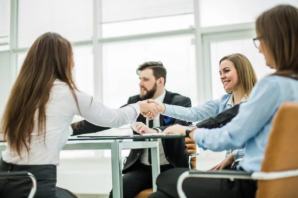 handshake business partners after discussing the terms of a new contract in the workplace in a modern office