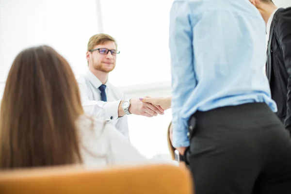 Bank Manager and the customer shake hands after signing a lucrative contract