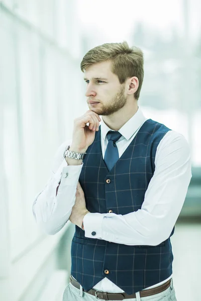 Thoughtful beginner businessman standing near the window — Stock Photo, Image