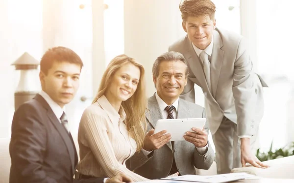 serious business team with tablet computers, documents having discussion in office