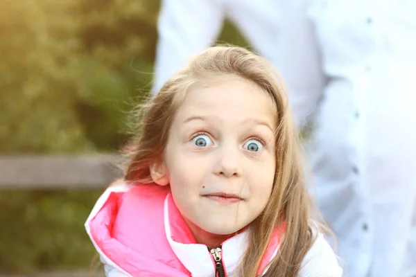 Porträt eines überraschten kleinen Mädchens bei einem Spaziergang im Park auf einem s — Stockfoto
