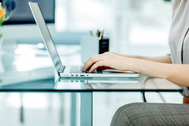 accountant working on a laptop with financial charts on the desktop. clipart