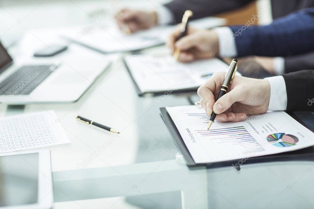 closeup of business team is working with the financial schedules in the workplace in the office