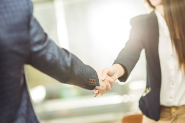 handshake business partners near the workplace clipart