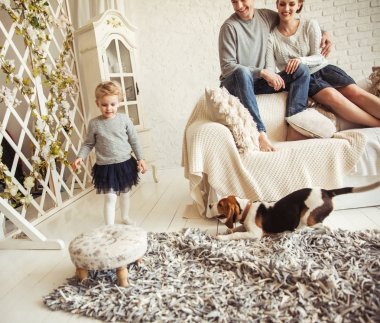 mutlu genç aile oturma odasında Pazar günü dinlenme