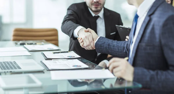 handshake of two lawyers after discussing the terms of a financial contract