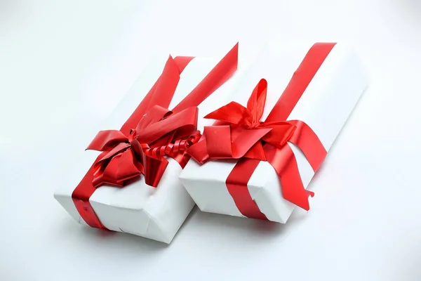 Closeup.boxes with gifts with a beautiful red ribbon — Stock Photo, Image