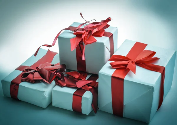 Closeup.boxes with gifts with a beautiful red ribbon — Stock Photo, Image