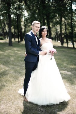 mutlu gelin ve damat bir Park arka plan üzerinde