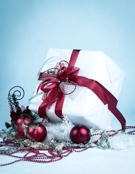Κουτί δώρου, σε ολόλευκο και χριστουγεννιάτικα διακοσμητικά σε λευκό φόντο — Φωτογραφία Αρχείου