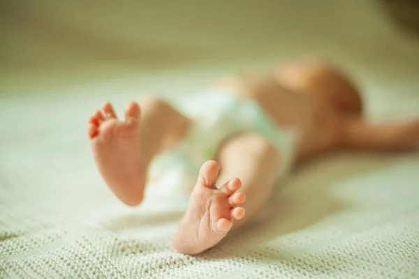 Gezondheid concept - close-up van de benen van een pasgeboren baby liggend — Stockfoto