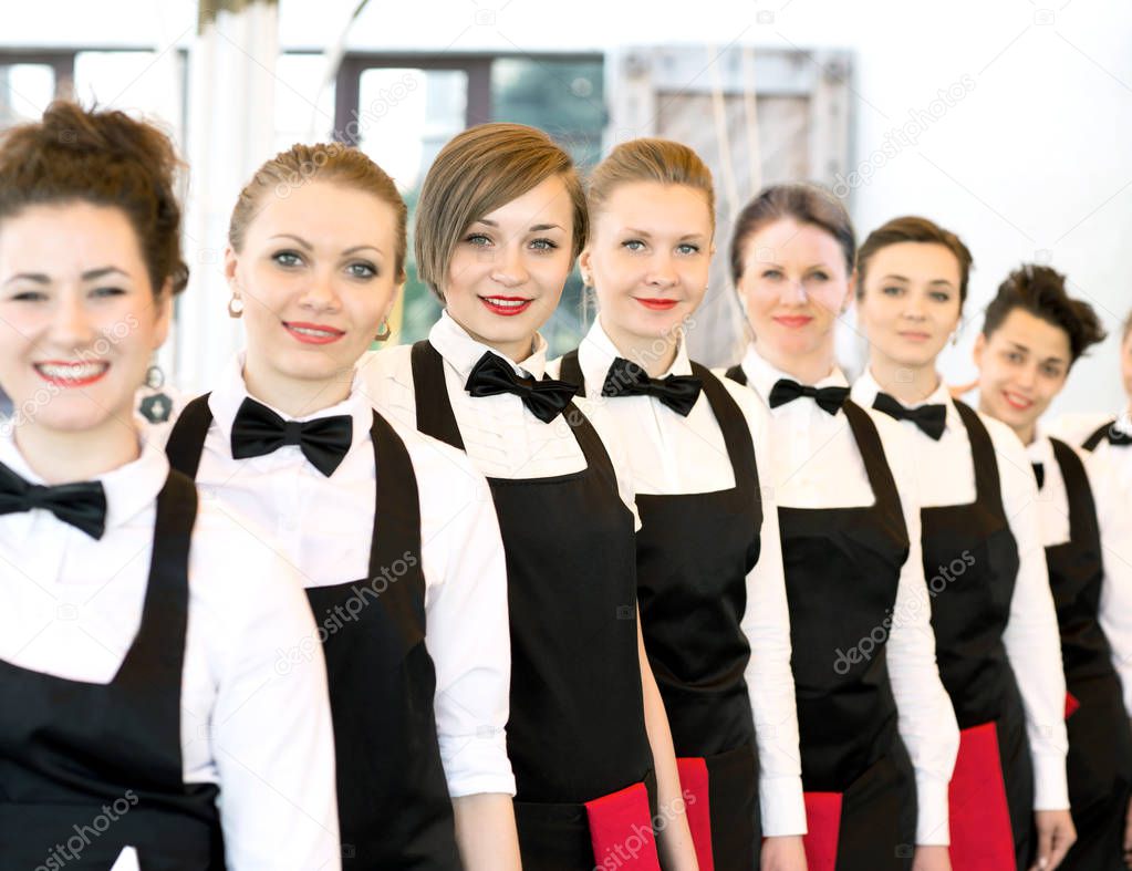 group of waiters at a prestigious restaurant standing in the col