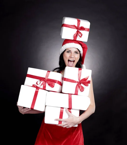 Jovem mulher feliz em traje de Papai Noel com lotes de Cristo — Fotografia de Stock