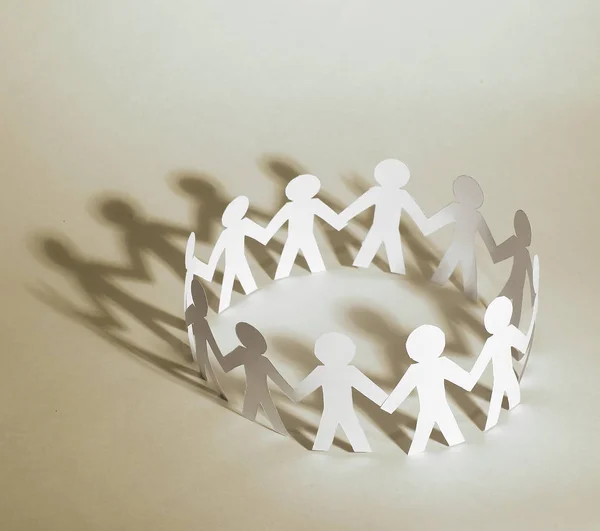 Business background.team paper men standing holding hands. — Stock Photo, Image