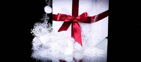 Box with Christmas present and Christmas decorations on a black — Stock Photo, Image
