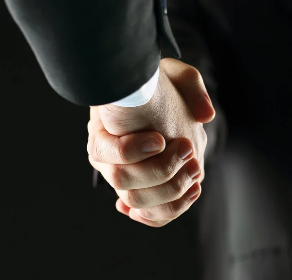 Kézfogás - kezében a fekete háttér — Stock Fotó