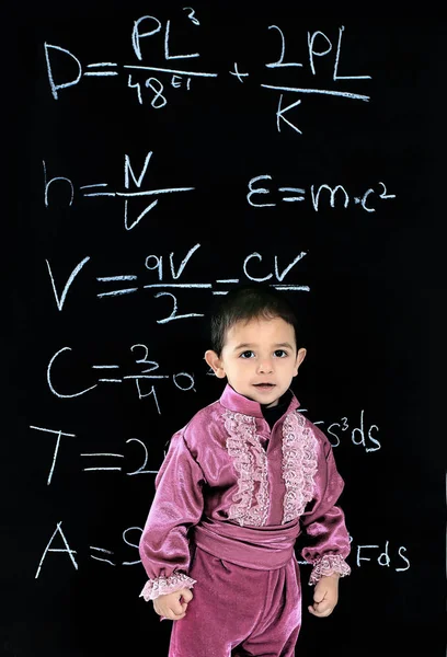 Little Gypsy boy in national costume standing near school blackboard — Stock Photo, Image