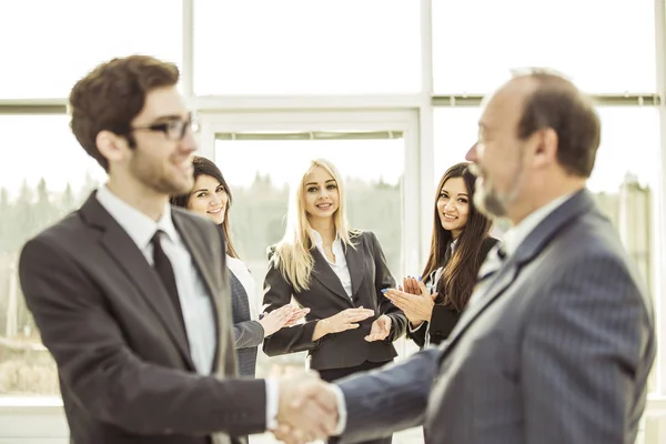 Handdruk zakenpartners voordat de zakelijke onderhandelingen over de achtergrond van applaudisseren beginnen — Stockfoto