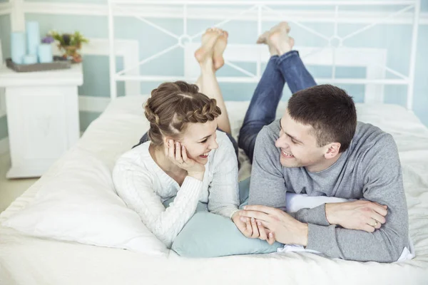 Concepto de felicidad familiar: pareja amorosa en la cama en el dormitorio — Foto de Stock