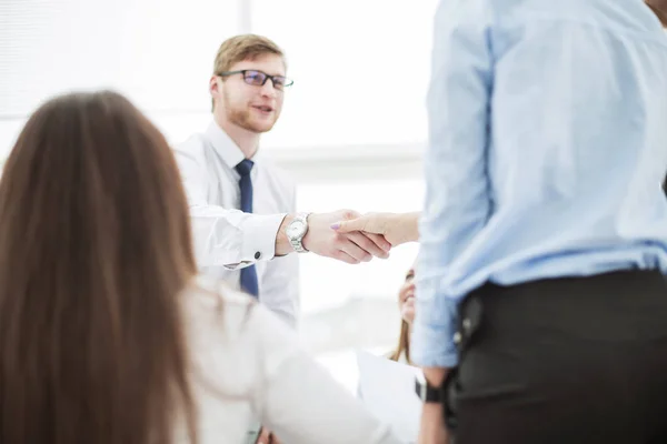 Bank Manager and the customer shake hands after signing a lucrative contract