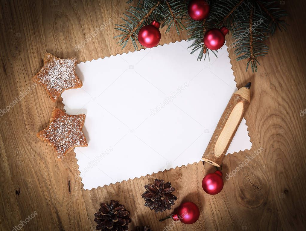 blank Christmas card and ornaments on wooden background.