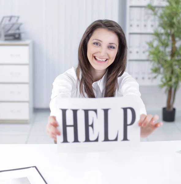 Smiling business woman showing a sheet with the word help — Stock Photo, Image