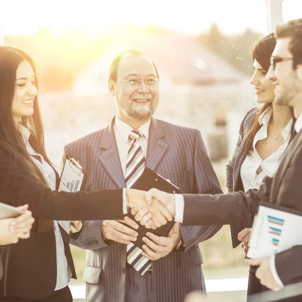 Stretta di mano partner finanziari, e gli avvocati della società sullo sfondo dell'ufficio — Foto Stock