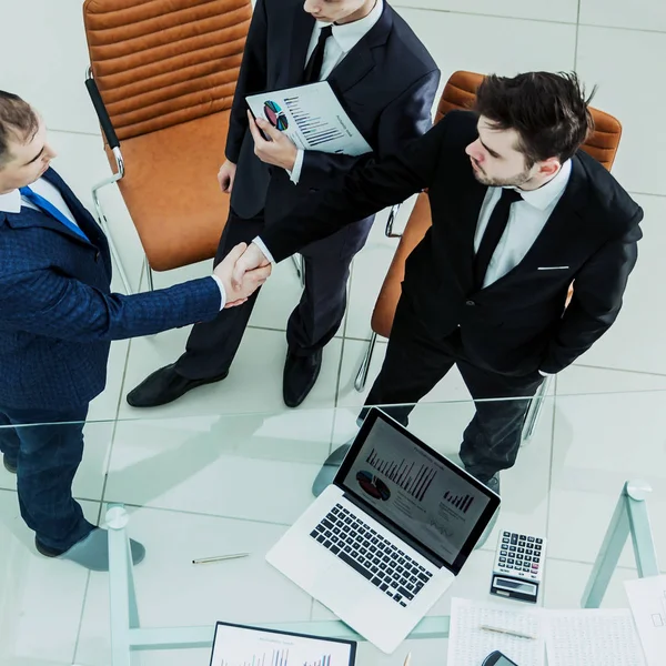 Handshake affärspartners innan man överväger en ny ekonomisk överenskommelse — Stockfoto