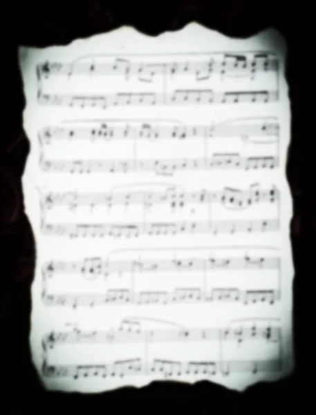 Folha de música vintage com bordas queimadas no borrão . — Fotografia de Stock