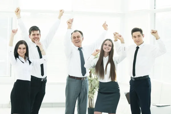 Grupo de jóvenes felices en ropa formal celebrando, haciendo gestos, manteniendo los brazos levantados — Foto de Stock