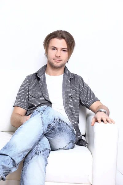 Confident stylish guy sitting in a chair — Stock Photo, Image