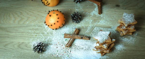 Christmas table. background image of cinnamon sticks,oranges an