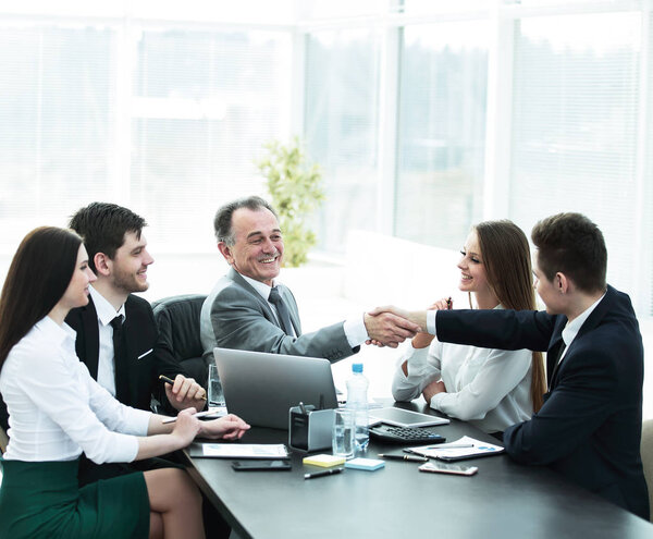 businessman and investor shake hands at the negotiating table