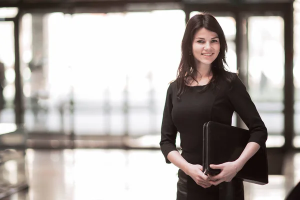 Successful business woman with documents on the background of a spacious office. — Stock Photo, Image