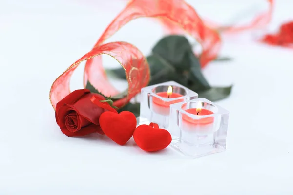 Two candles and a beautiful rose on a white background — Stock Photo, Image