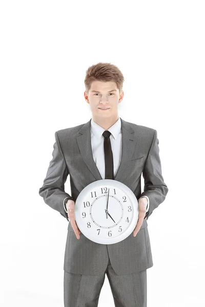 Homem de negócios bonito segurando um grande relógio. Isolado em um branco — Fotografia de Stock