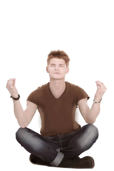 Hombre moderno medita sentado en el suelo —  Fotos de Stock