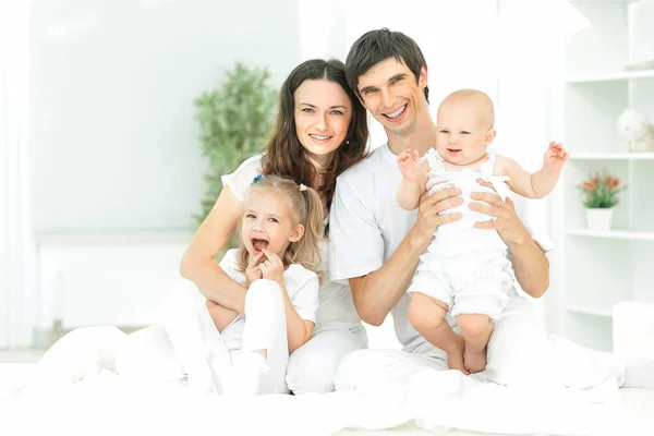 Modern happy family on a Sunday in the nursery — Stock Photo, Image