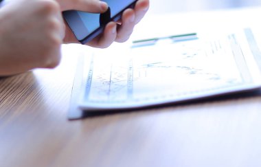 close up. businessman using smartphone to check financial data