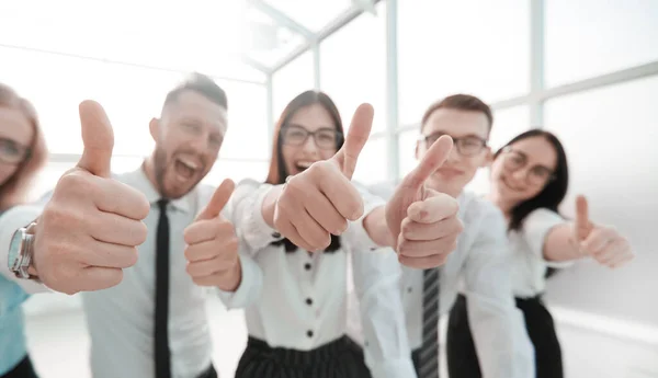 Close up. happy business team showing thumbs up. — Stock Photo, Image