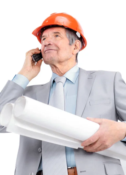 Senior engineer with blueprints talking on cell phone. — Stock Photo, Image