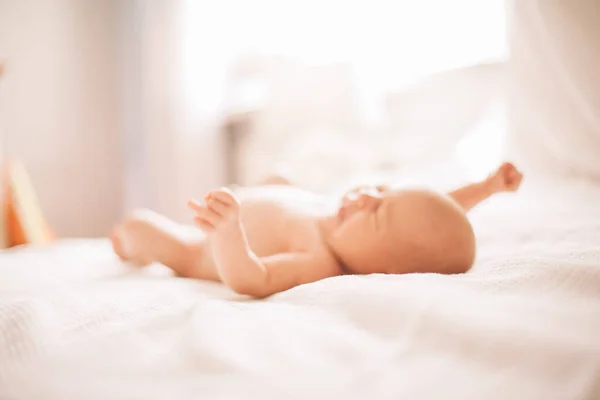 Retrato de un bonito bebé recién nacido acostado en la cama. foto con espacio de copia —  Fotos de Stock