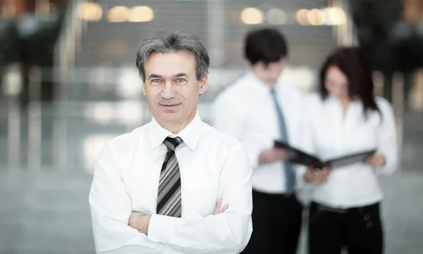 Serious businessman on the background of business team. — Stock Photo, Image