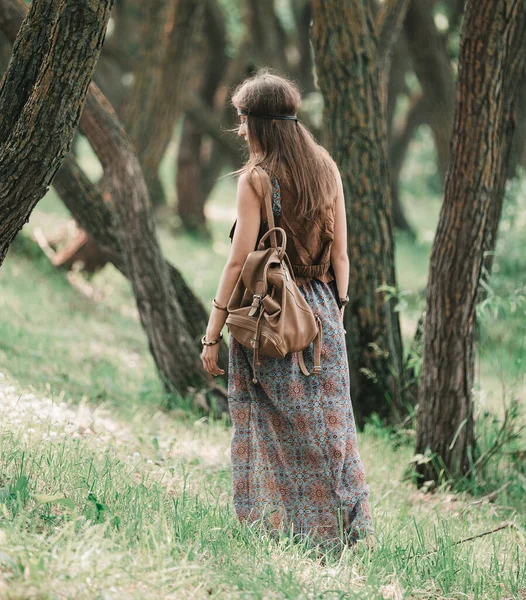 attractive hippie girl walking through the forest